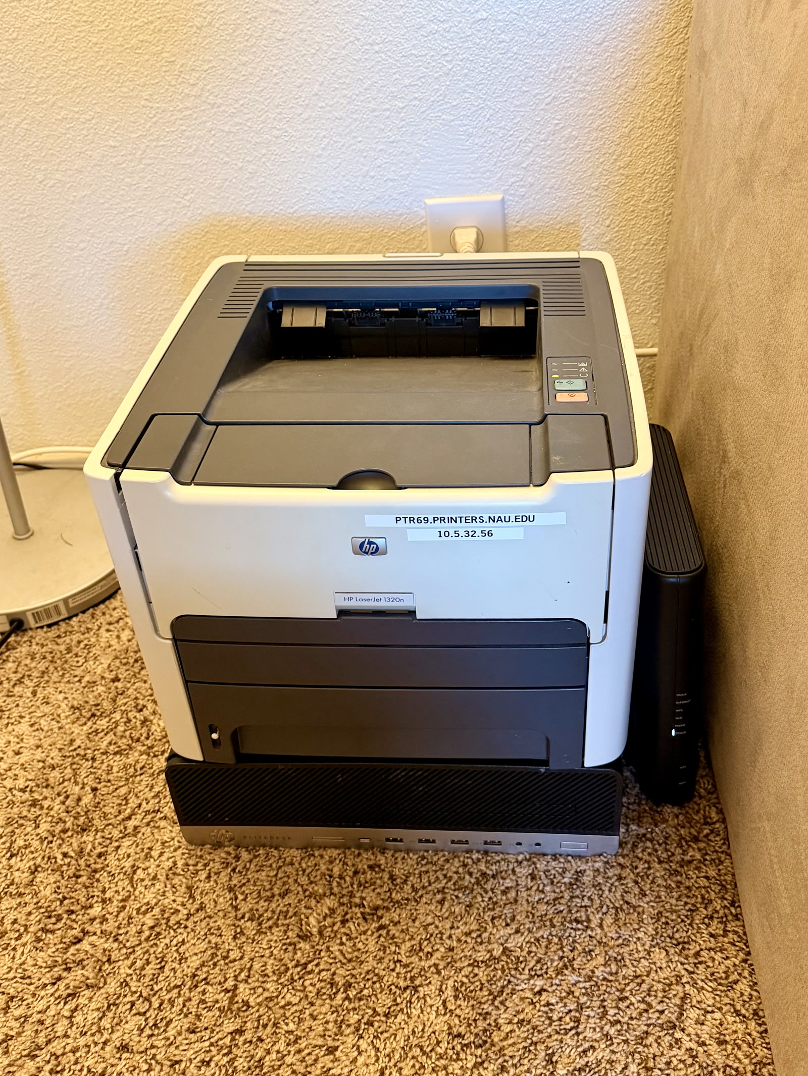 The more organized corner of the homelab, with the printer and server stacked together instead of spread across the floor